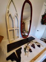 Overview photo showing all the decor items including the mirror, gothic window frame, wall shelf plank, brackets, and wall sign.