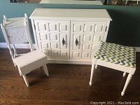 White wooden cabinet, small chair, and upholstered stool arranged on wooden floor