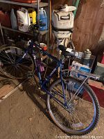 Blue KHS Montana mountain bike with rear rack, water bottle holder, black and white seat.