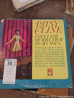 Front cover of Patsy Cline vinyl LP titled 'Gotta Lot of Rhythm In My Soul' with worn edges and aged colors.