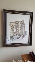 Framed print of Birks Building building with visible signature, numbering, and dark wooden frame