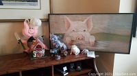 Shelf with pig figurines and barn board painting of pig