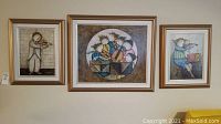 Three framed artworks hung side by side showing a standing violinist, a circular ensemble of musicians, and a seated musician