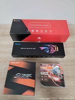 Four boxed car accessories displayed on table: OSRAM HB3 bulbs, Sealight Scoparc LED lighting, Govee RGB strip light, and Junsun HD mirror recorder.