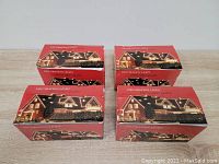 Four red boxes labeled 'Decoration Light' with pictures of a house decorated with Christmas lights, stacked and unopened showing packaging.