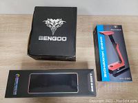 Photo of boxes for BENGOO headphones, Luxcoms mouse, and Beexcellent GM290 gaming microphone.