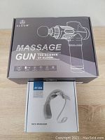 Closed box of ALDOM massage gun showing brand, model, and features