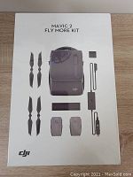 Front of sealed retail box showing printed images of included accessories