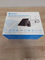 Box packaging showing brand YESKAMO and main features including wire-free, rechargeable, 1080P, motion detection, PIR sensor, night vision, audio, micro SD, cloud, antenna.