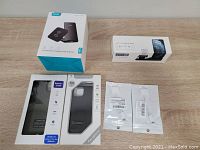 Photo shows all packaged items in the lot including wireless charging pad, charging cases, and adapters