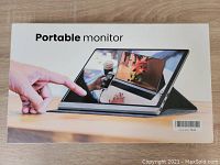 Box of the iVV portable monitor showing an example image of the monitor in use with a touchscreen scenario.