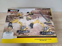 Box front of the HUI NA branded RC excavator truck toy showing multiple types of vehicle models and action features
