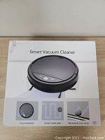 Closed box of the YUNTUO smart vacuum cleaner showing top-side image and features like touch button, smart route planning, and anti-drop sensors.