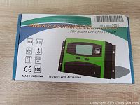 Photo of boxed PWM Solar Charge Controller showing front side with model name and icons indicating features