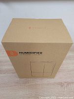 Closed box showing Taotronics branding and humidifier illustration on cardboard packaging.