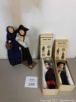 Four Amish dolls, two unboxed and two in original boxes, displayed together.