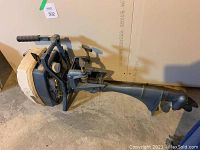 Full side view of the grey and white Eska 4.5HP outboard motor showing throttle handle and propeller.