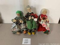 View of three Renates Little People cloth dolls with accessories.