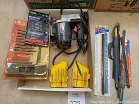 Full lot showing the jigsaw, various jigsaw blades in sets, hacksaw blades, and hacksaw frame.