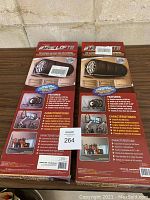 Front and back views of the original packaging showing product features and branding for Tire Loft racks.