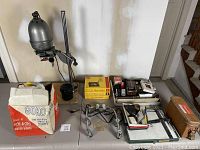 Wide view of tabletop displaying editor viewer, lamp, boxes, frames and accessories