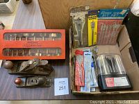 Overview of lot showing two hand planes, boxed Forstner drill bits, and assorted packaged drill and spade bits.