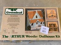 Box front with product name and images of completed dollhouse model showing front and side views