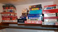 Shelf view showing left stack of jigsaw puzzles and right stack of board games