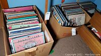 Two cardboard boxes filled with assorted vinyl LP records