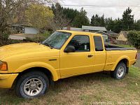 Passenger side view of yellow extended cab body and door panels