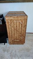 Side view of large bamboo storage chest showing woven bamboo pattern and rectangular raised detailing