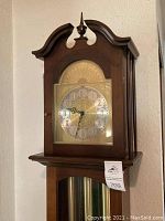 Upper case with bonnet top, finial and clock face