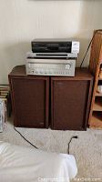 Full view of Scott speakers stacked with Aiwa receiver, Sony DVD player/recorder, Sharp VCR on top