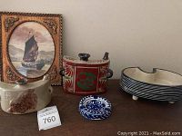 Overview of all items on surface: two ceramic hip flasks, bonsai pot, ashtray, and framed sailing ship print