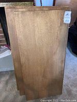 Top view of three oak boards stacked together showing front surfaces and grain.