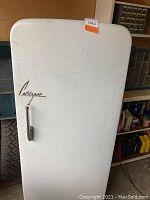White Coldspot refrigerator exterior with Coldspot script logo and chrome handle