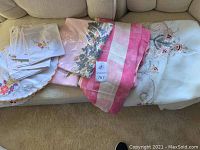 Lot of various linens including embroidered and Hawaiian linen tablecloths, some packaged, plus handkerchiefs.