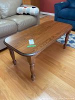 Angle view from the corner showing the tabletop and legs with surrounding furniture for context.