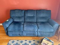 Front view of the blue La-Z-Boy reclining sofa showing three-seat cushions, with a secondary cushion detail and visible separate backrests.