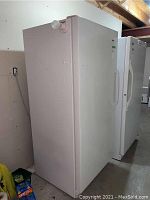White Danby upright refrigerator shown from diagonal front perspective