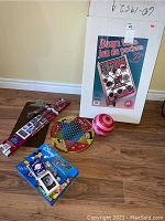 Photo of Wood Bean Toss Game and other games including Disney Bingo, round ball, wooden Chinese checkers board.