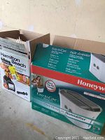 Photo shows Honeywell Cool Moisture Humidifier box and Hamilton Beach MultiBlend Blender box stacked side by side.