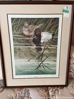 Framed signed and numbered print showing two ducks in water with reeds, signed 'Garcia'