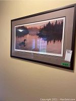 Framed and matted print by Neil Blackwell on wall showing the nature scene with duck and forest reflections
