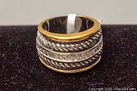 Close up photo of front/top of 925 sterling silver ring with gold tone rims and twisted rope detailing