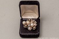 Photo showing ring with cluster of multicoloured freshwater pearls inside a black velvet box