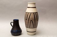 Photo of both the pitcher and vase showing size and design contrast.