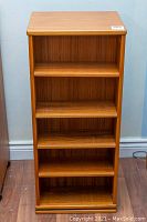 Front view of teak veneer bookshelf showing five shelves