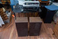 Full lot view showing DENON DRA-275R receiver, TECHNICS RS-B18 cassette deck on a table with a pair of MIRAGE SM-1 speakers on the floor.