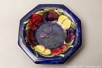 Top view of the octagonal bowl showing colorful fruit design on blue background